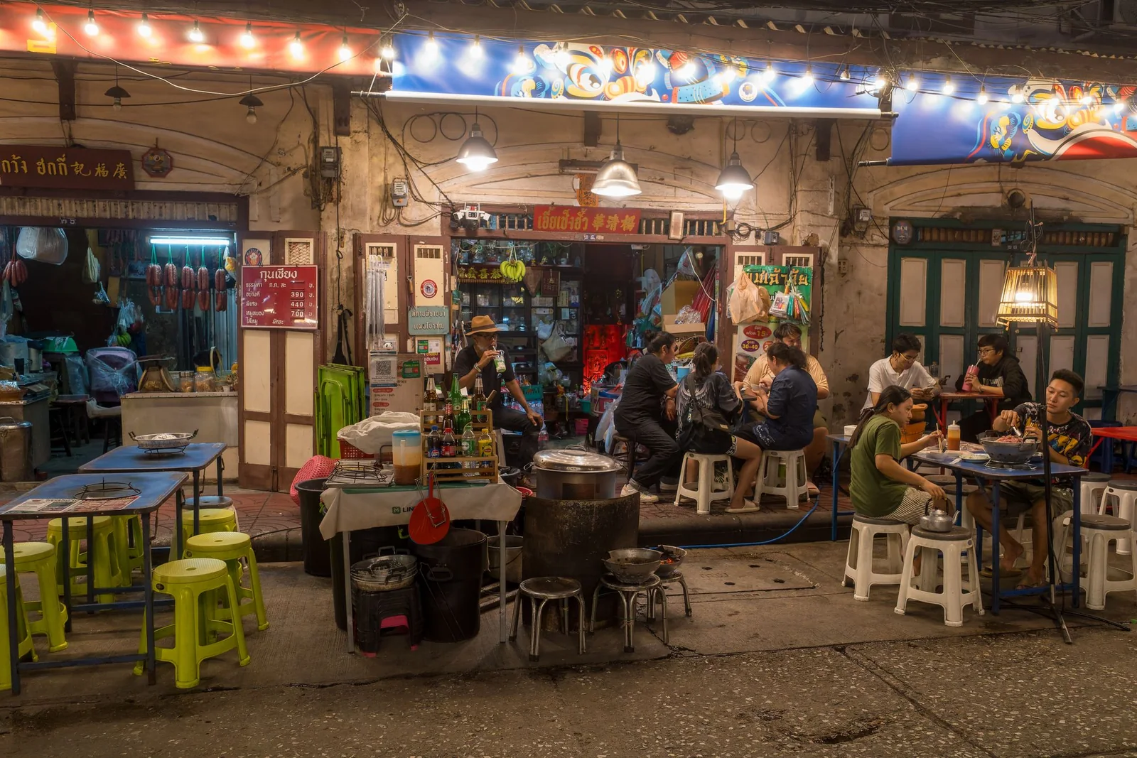 People dining at a Bangkok street-food venue at night