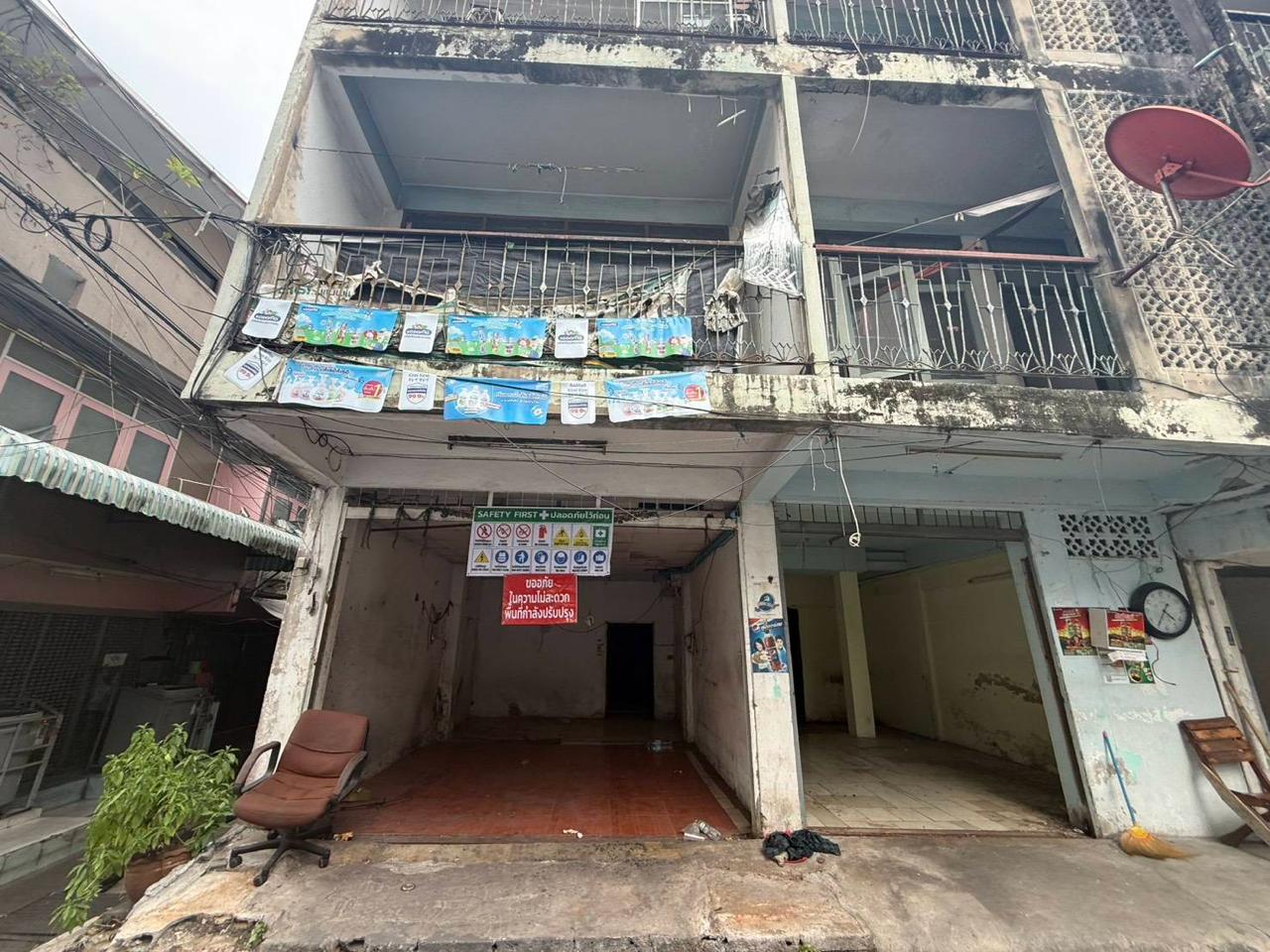 Full weathered facade of the building before the next layer of renovation progress