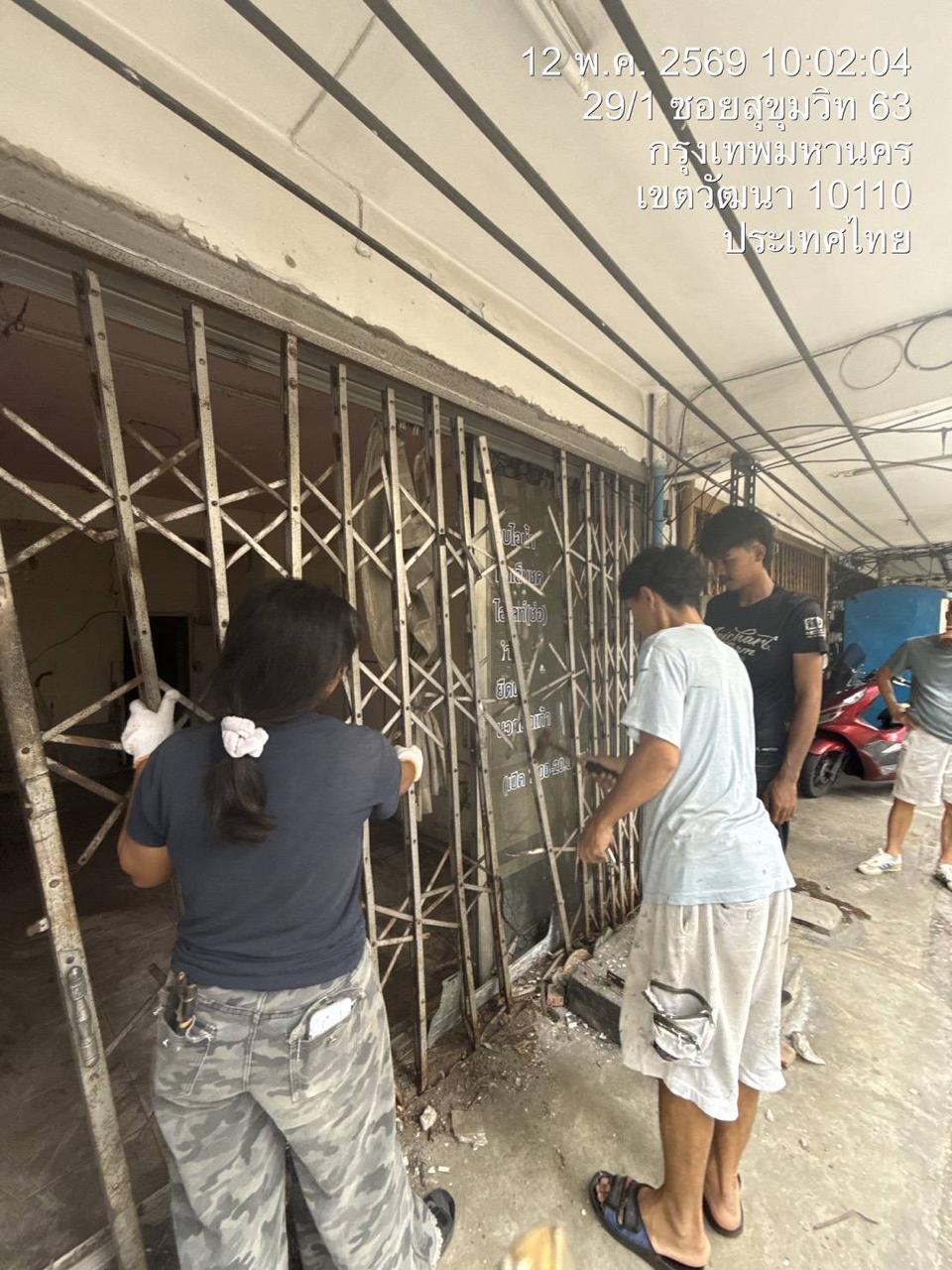 Team working on the old folding gate and entrance frontage at WITHIN