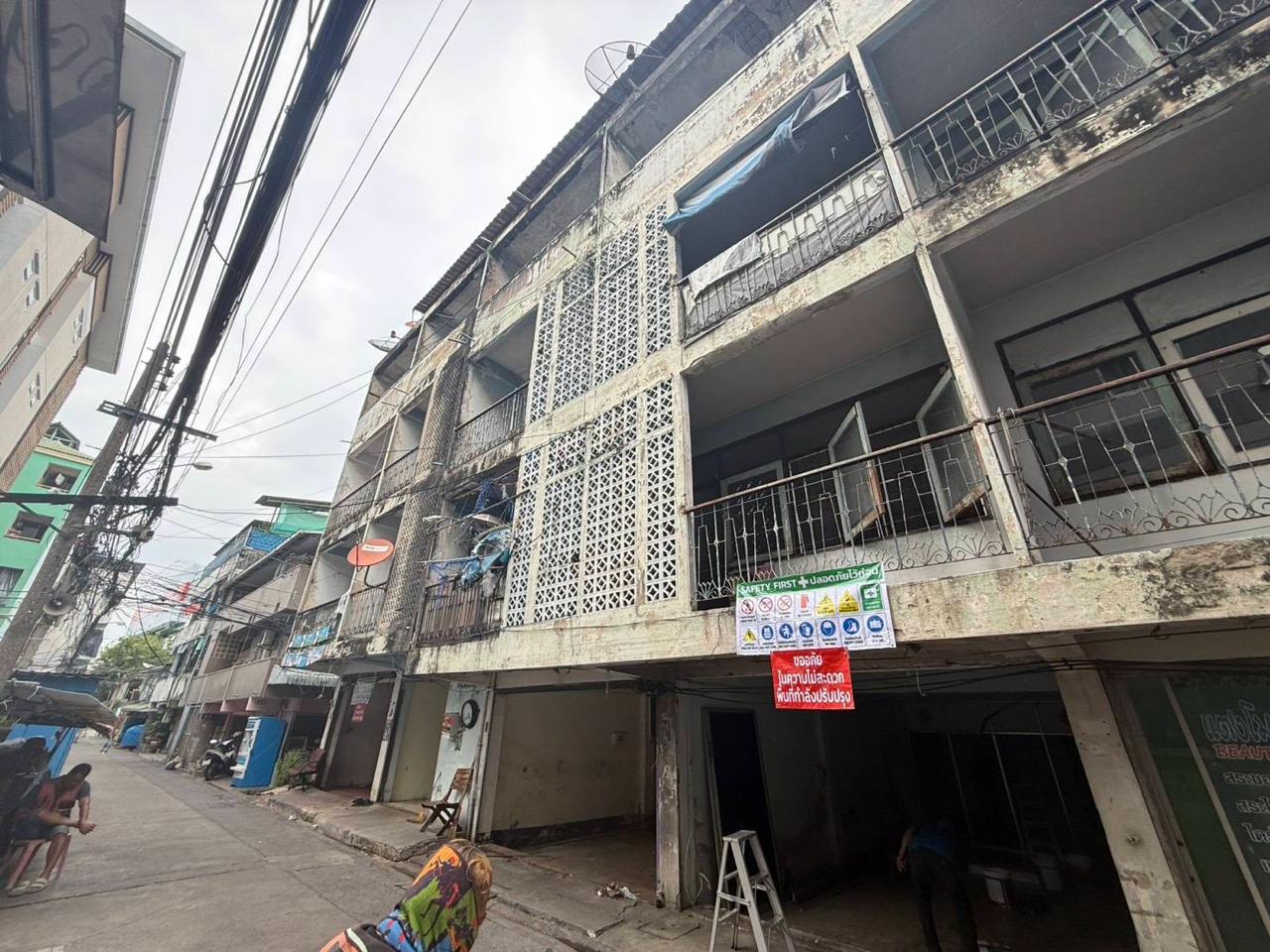 Street view showing the wider building context and neighborhood around the WITHIN renovation