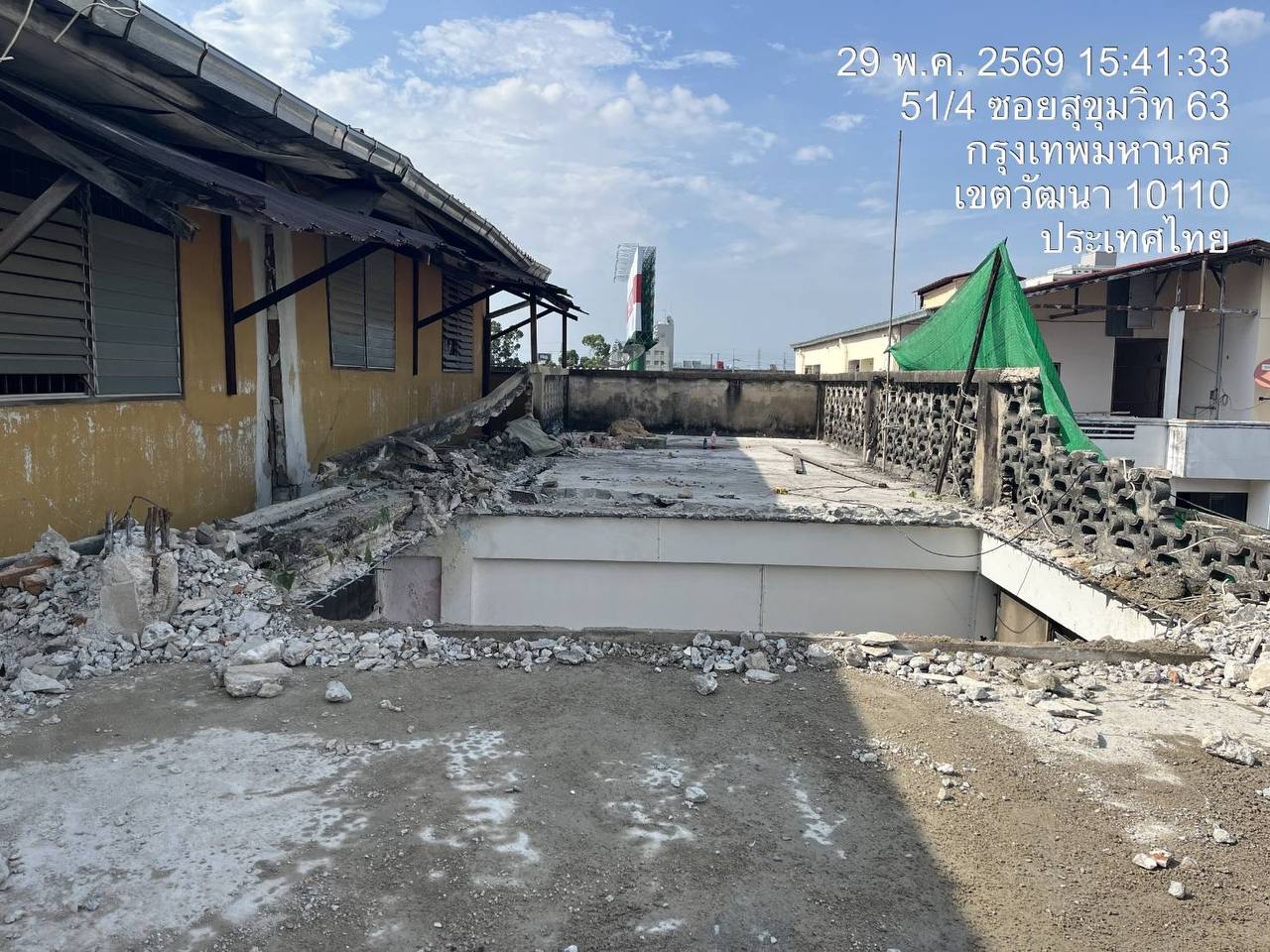 Fifth-floor slab at WITHIN showing a large opening cut through the floor with rubble gathered along the perimeter