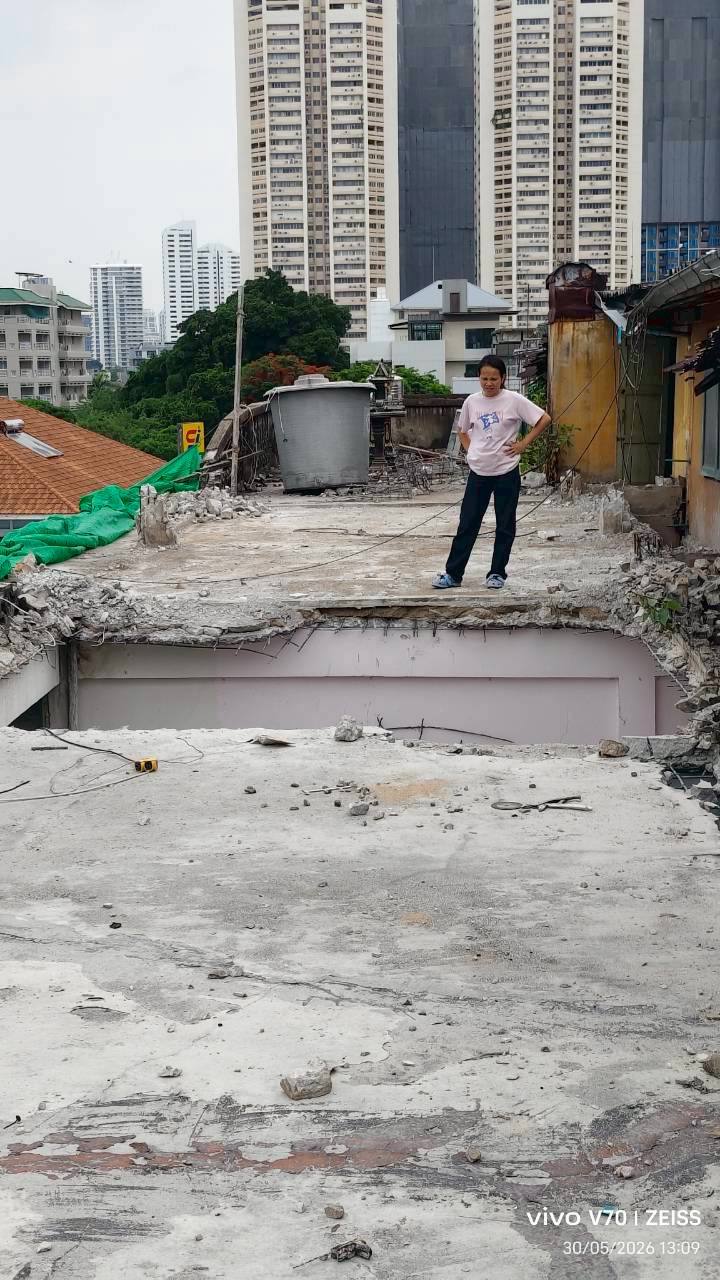 Vertical view across the fifth floor at WITHIN with the slab opening in the foreground and a person standing beyond it for scale