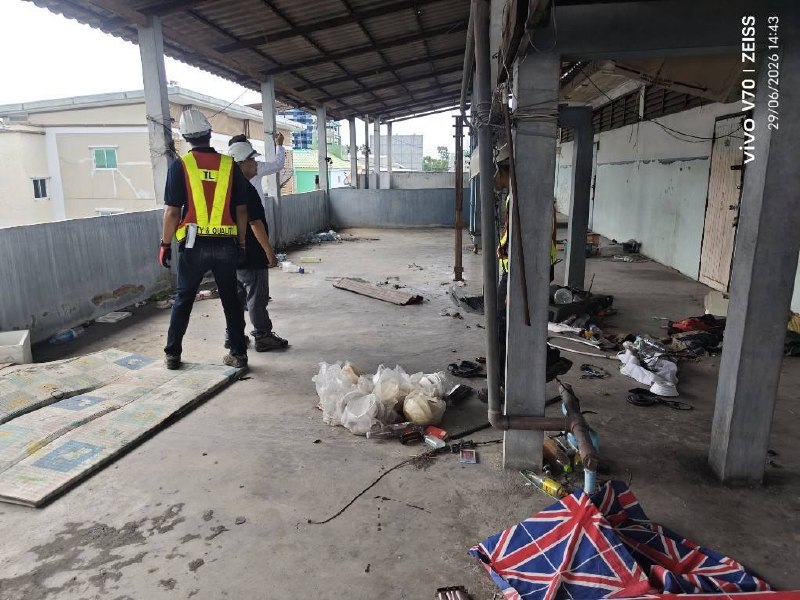Thai Lift Company staff standing on an upper level of the main building at WITHIN while reviewing the exposed concrete slab, steel columns, and open perimeter conditions during an early structural inspection