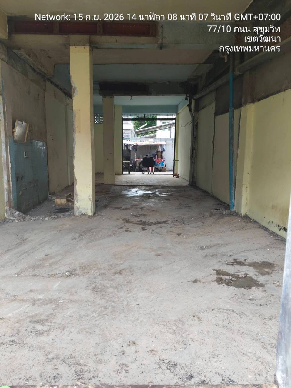 Cleared ground-floor shophouse at WITHIN with removed internal partitions, exposed columns and services, and a long open view through the building