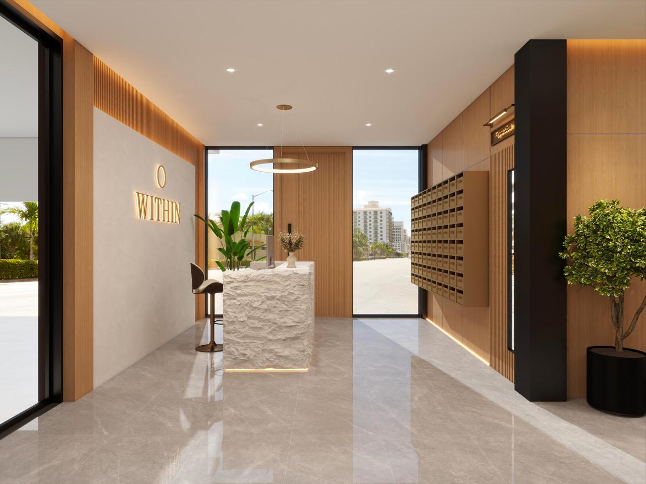 WITHIN lobby with centered reception desk, right-side mailboxes, and the entry door beyond