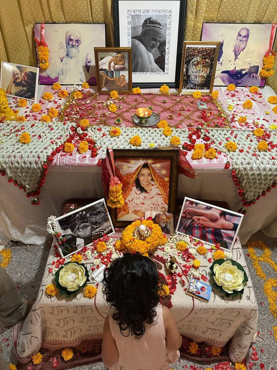 Flower-covered altar with photographs of Maharaj-ji at the existing Neem Karoli Baba Center in Bangkok